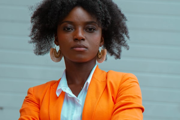 Businesswoman in an orange blazer scaling her brand nationwide