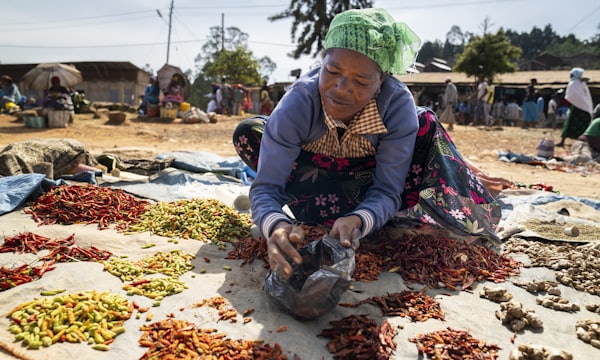 Market woman arranging the goods on her stall