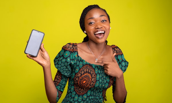 Woman smiling at the mobile money payment on her phone
