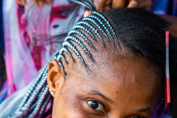 Client smiling while having her hair styled at a salon